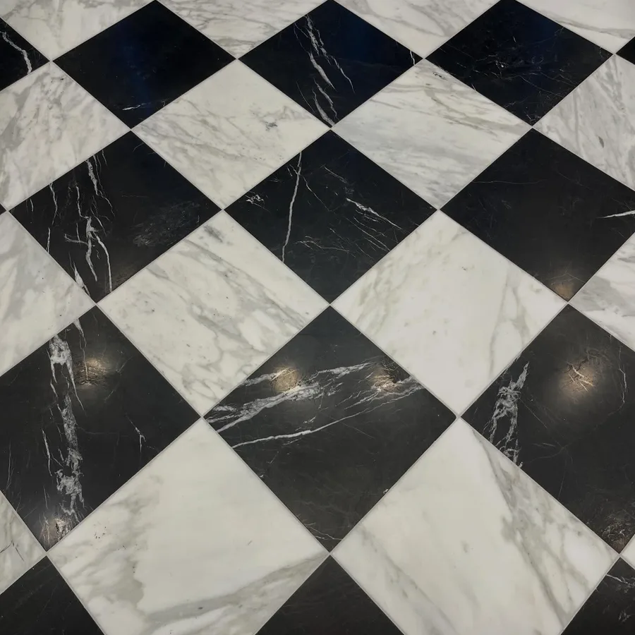 The black-and-white marble checkerboard floor at the entrance